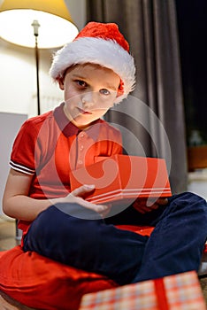 Little boy opening a Christmas gift