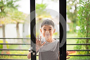 Little boy opening door into the house