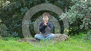 Little boy outdoor praying and meditating