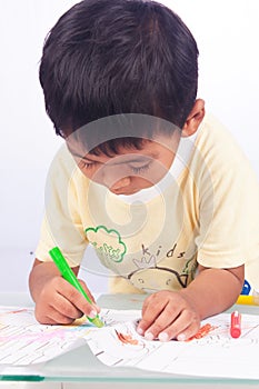 Little boy paint color on white paper on white backgroun