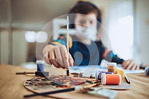 Little boy painting a picture in home studio
