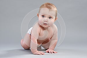 Little boy in pampers crawling