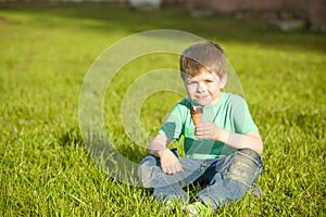 Little boy in park eating ice cream