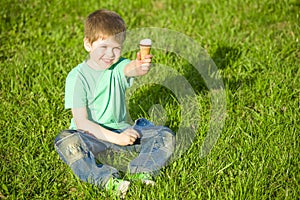 Little boy in park eating ice cream