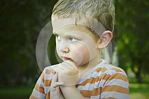 Little boy in the park.wet child after rain.handsome boy with blue eyes