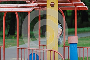 Little boy peeping on the children`s playground