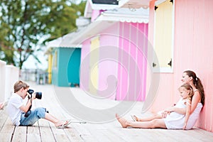 Little boy photographing his family