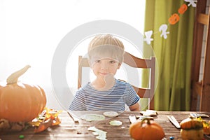 Little boy in pirate costume on Halloween trick or treat. Kids carving pumpkin lantern. Children celebrate Halloween. Family trick