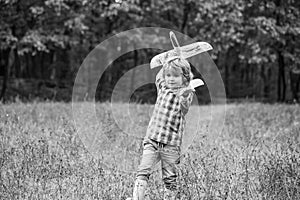Little boy with plane. Child playing with toy airplane. Black and white