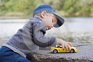 Little boy play with a car