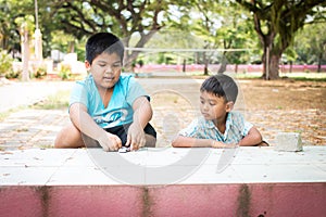 little boy play toy car in the green park