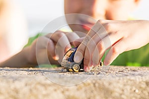 Little boy play with a toy car summer outdoor. Little kid plays outdoor with toy car