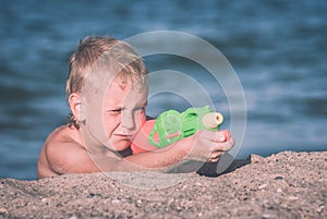 Little boy play with water gun 3. Instagram stylization