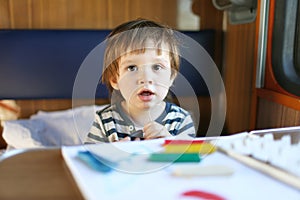 Little boy with playdough on train