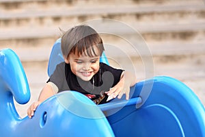 Little boy on playground equipment