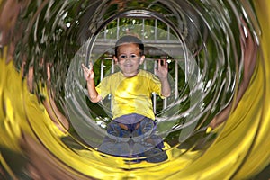 Little boy in playground tube