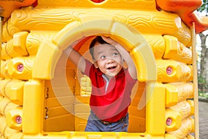 Little boy in playhouse