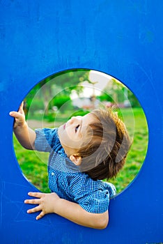 Little boy in playhouse