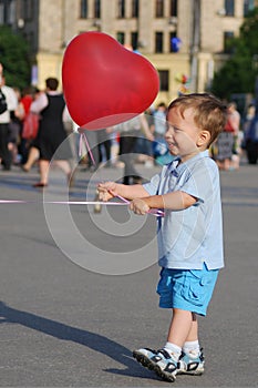 Little boy playing with air balloon