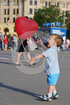 Little boy playing with air balloon