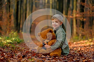 A little boy playing in the autumn park.