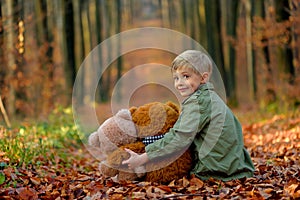 A little  boy playing in the autumn park.