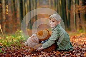 A little  boy playing in the autumn park.