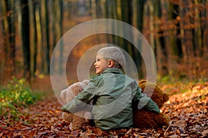 A little  boy playing in the autumn park.