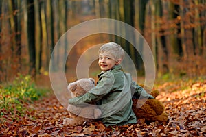 A little  boy playing in the autumn park.