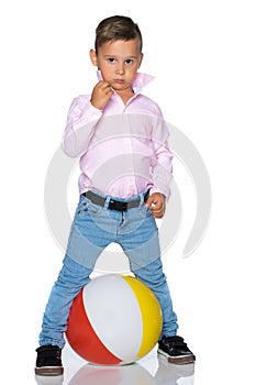 A little boy is playing with a ball.