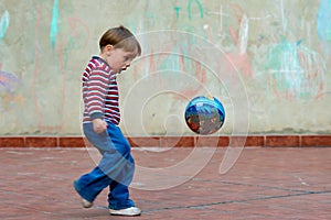 Little boy playing with a ball