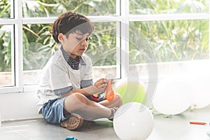 Little boy playing balloons in party