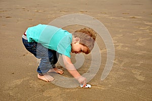 Little boy playing on the beach