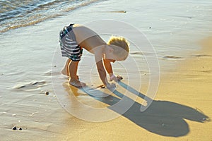 Little boy playing on the beach. Vacation on sea resort