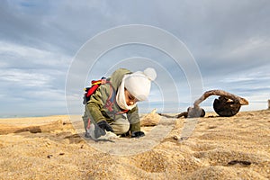 Little boy playing on beach in winter