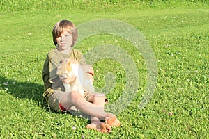 Little boy playing with a cat