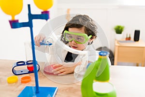 Little boy playing with a chemistry game