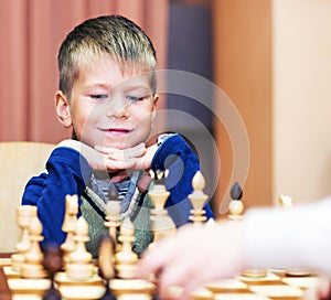 Little boy playing chess