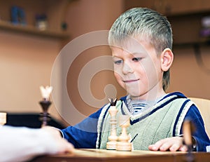 Little boy playing chess