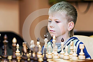 Little boy playing chess
