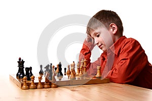 Little boy playing chess