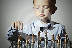 Little boy playing chess.Smart kid.genius Child. Intelligent game.Chessboard