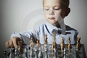 Little boy playing chess.Smart kid.Little genius Child. Intelligent gam