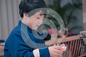 little boy playing the Chinese zither