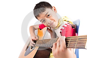 Little boy playing classic guitar course on white background