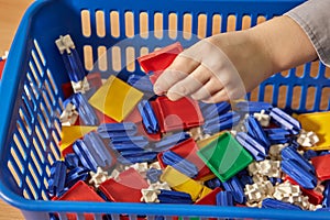 A little boy is playing with a colorful constructor. A child in kindergarten.