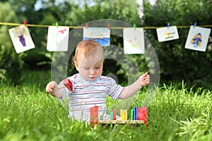 A little boy is playing with colorful wooden toys