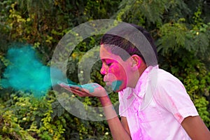 Little boy playing with colors, In a happy mood, Concept for Indian festival Holi