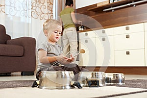 Little boy playing with cooking pots