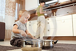 Little boy playing with cooking pots